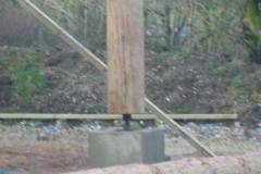 Large bolts under posts, (to be lowered allowing for wall settlement)